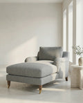 Gray English roll arm lounge chaise with matching ottoman in a bright room