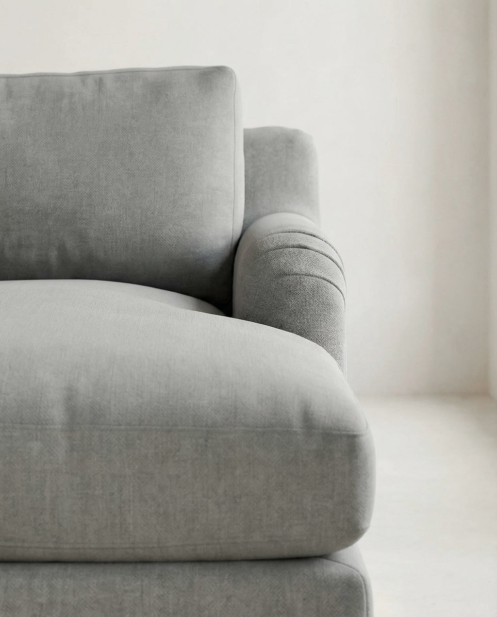 Gray sofa in a minimalistic room with a neutral color palette