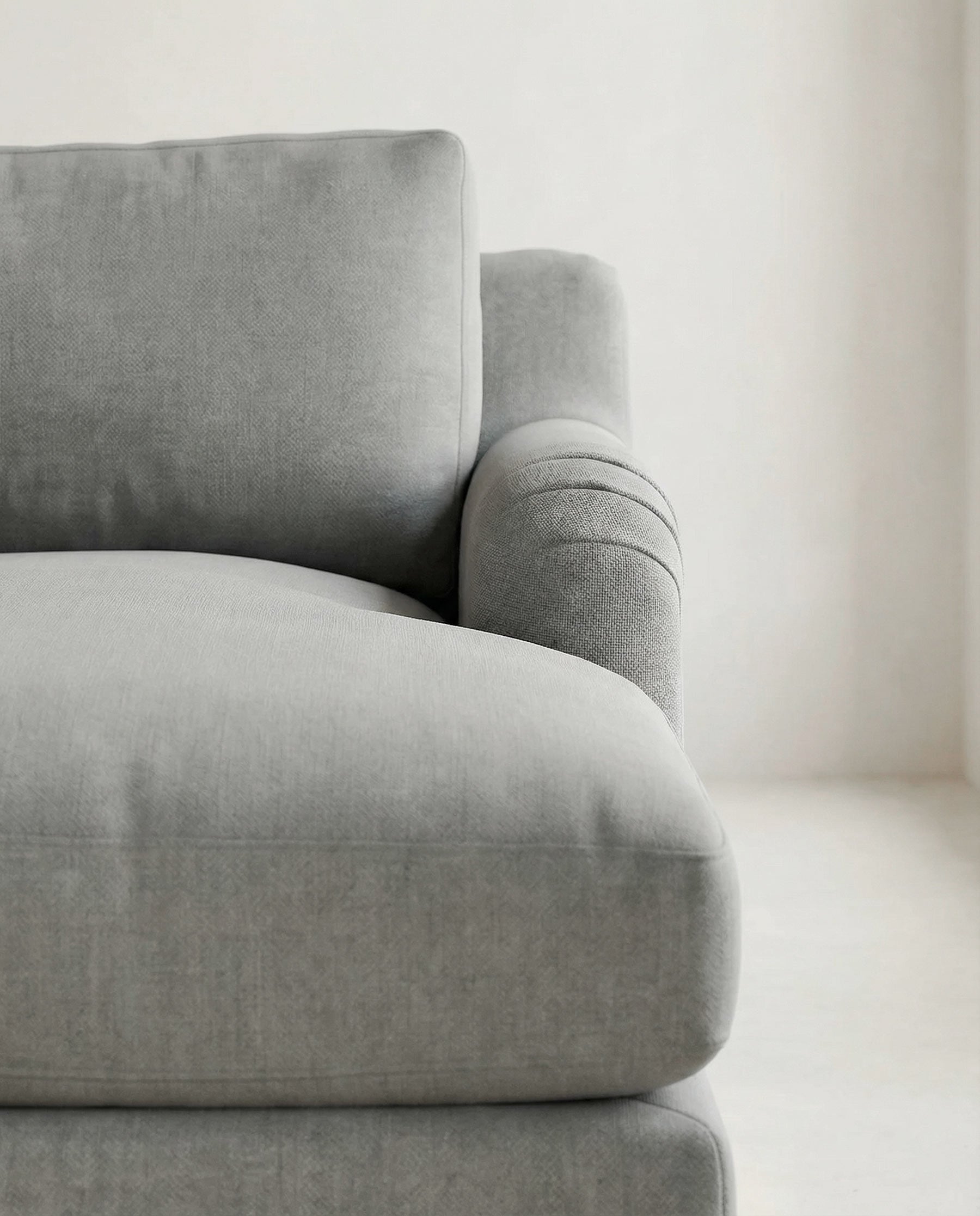 Gray sofa in a minimalistic room with a neutral color palette